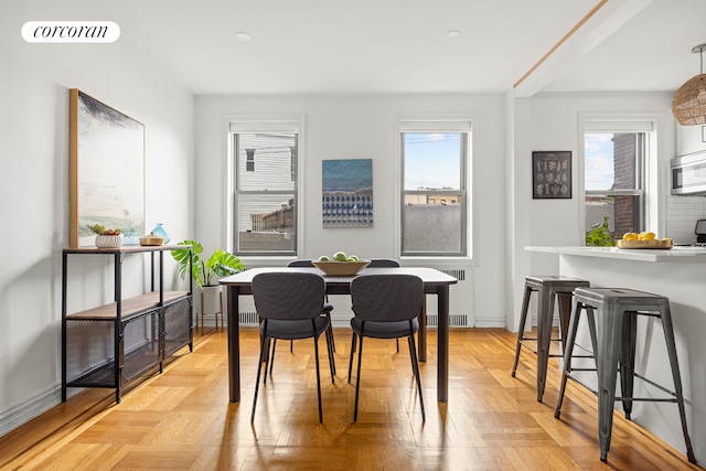 dining space with radiator, visible vents, and baseboards