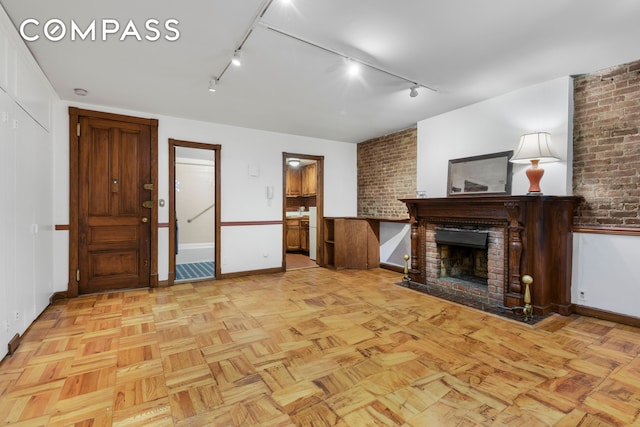 unfurnished living room featuring a brick fireplace