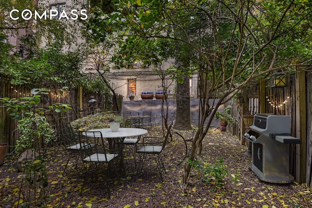 view of yard featuring outdoor dining area and a fenced backyard