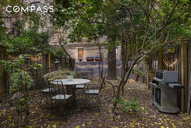 view of yard featuring a fenced backyard and outdoor dining area