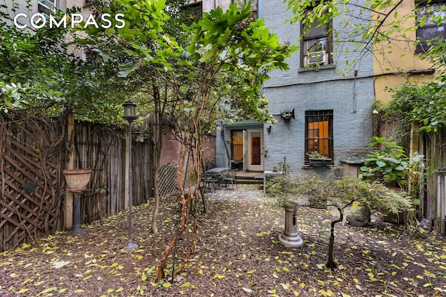 exterior space with fence and brick siding