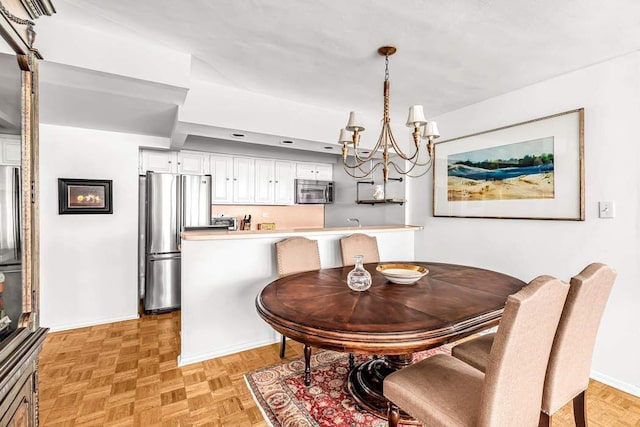 dining space with a notable chandelier and light parquet floors