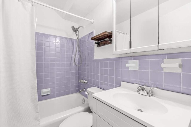 full bathroom featuring vanity, shower / bath combination with curtain, decorative backsplash, tile walls, and toilet