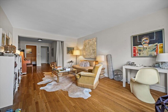living room featuring wood finished floors and baseboards
