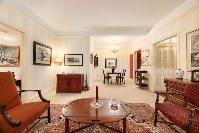 sitting room featuring ornamental molding, a chandelier, and light carpet