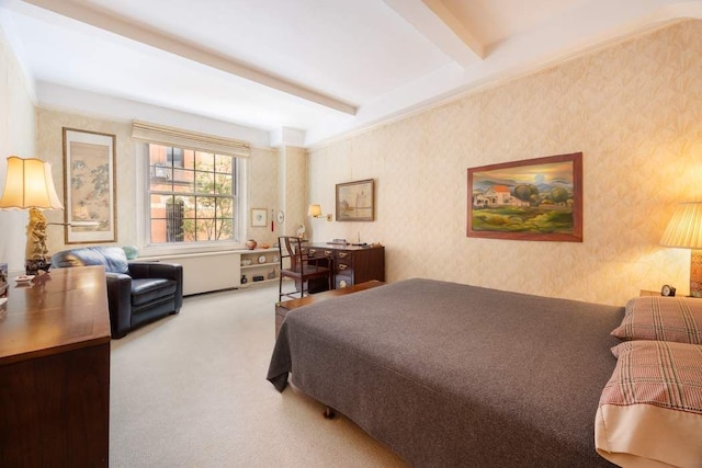 bedroom with beamed ceiling and carpet flooring