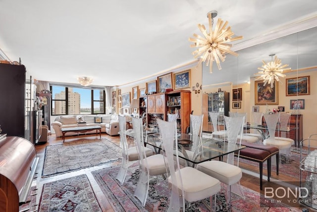dining area featuring ornamental molding, wood finished floors, and a chandelier