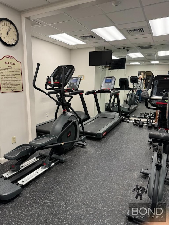 workout area featuring visible vents and a drop ceiling