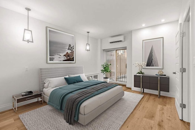 bedroom featuring light wood-type flooring, a wall mounted AC, and access to outside