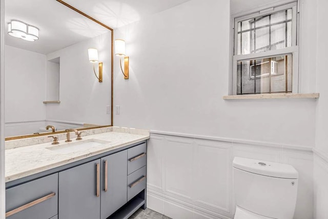 bathroom with toilet and vanity