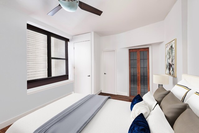 bedroom with ceiling fan and hardwood / wood-style floors