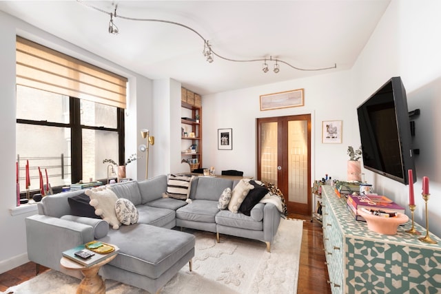 living room featuring hardwood / wood-style flooring, track lighting, and french doors