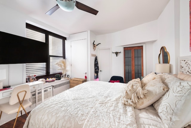 bedroom featuring french doors, ceiling fan, hardwood / wood-style flooring, and radiator heating unit