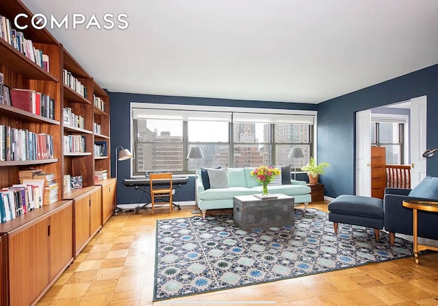 sitting room with plenty of natural light and baseboards