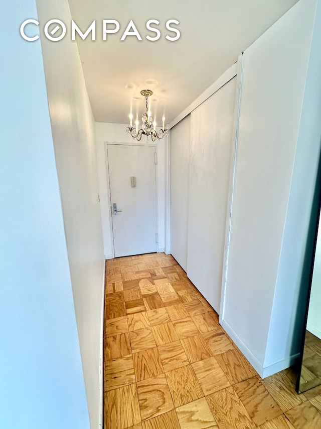 corridor with a notable chandelier