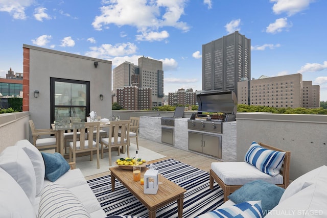 view of patio / terrace with outdoor dining area, an outdoor kitchen, outdoor lounge area, grilling area, and a view of city