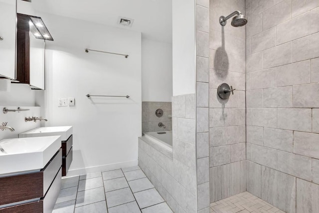 bathroom featuring tile patterned floors, vanity, and plus walk in shower