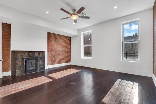 unfurnished living room with recessed lighting, a fireplace, wood finished floors, and baseboards