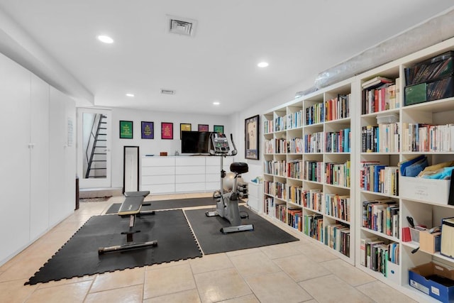 workout area featuring tile patterned flooring, visible vents, and recessed lighting