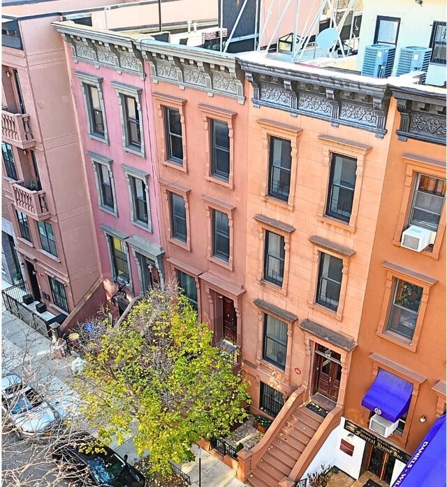 view of property featuring cooling unit and central AC unit