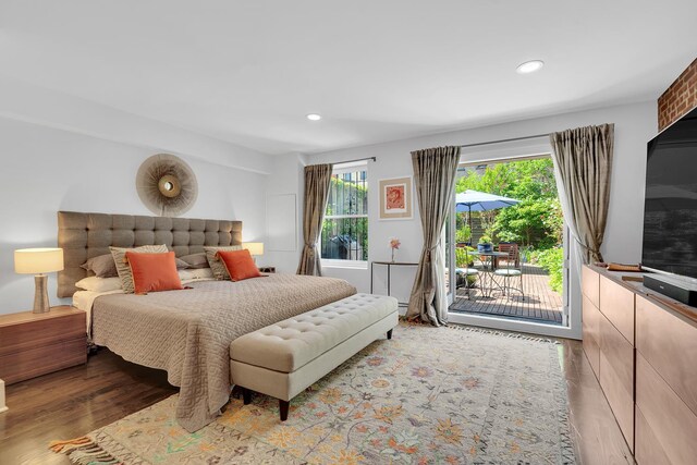 bedroom featuring wood finished floors, recessed lighting, and access to outside