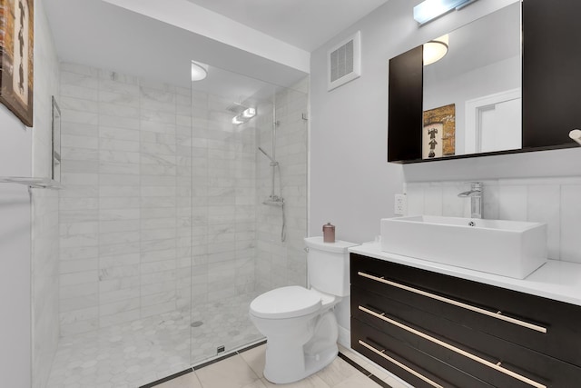 bathroom with toilet, a shower stall, visible vents, and vanity