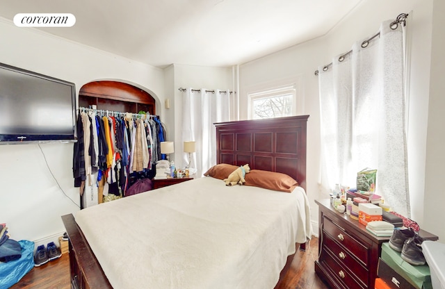 bedroom with a closet and dark hardwood / wood-style flooring