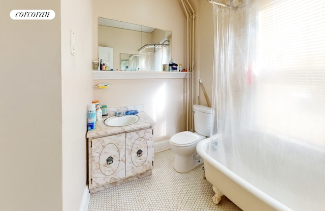 full bathroom featuring toilet, shower / bath combination with curtain, and vanity