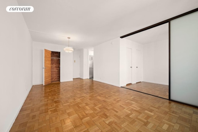 unfurnished room featuring parquet floors