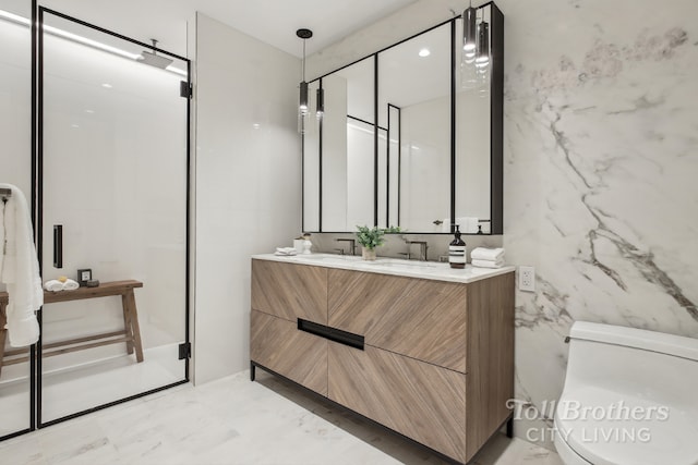 bathroom featuring toilet, tile walls, and vanity