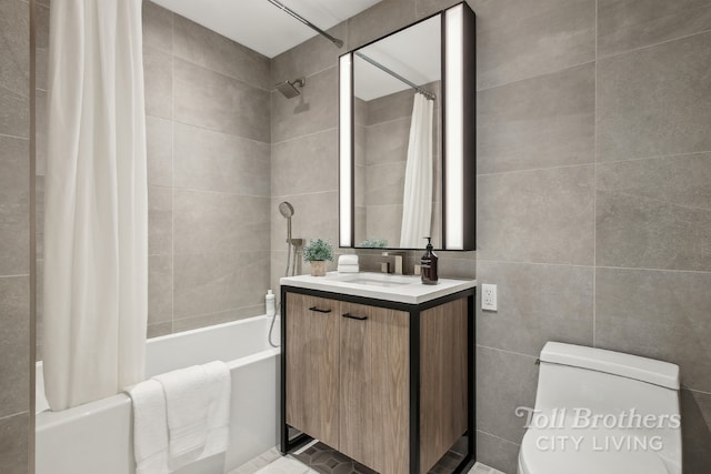 full bathroom featuring toilet, shower / bathtub combination with curtain, vanity, and tile walls