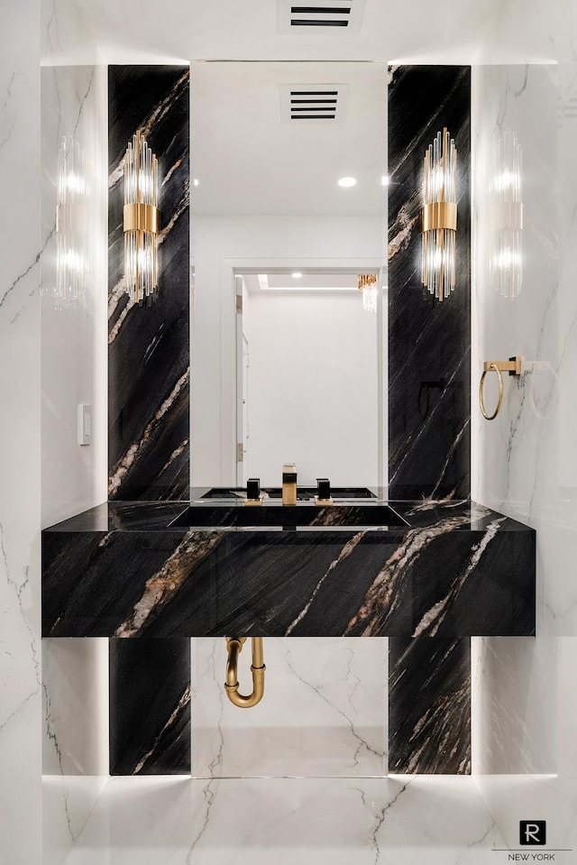 bathroom with marble tiled flooring