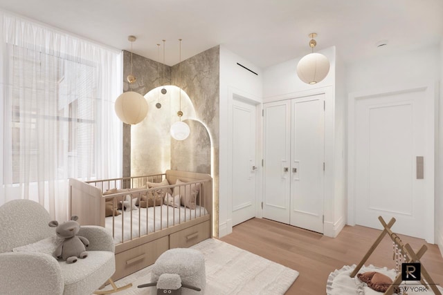 bedroom featuring light wood-style flooring