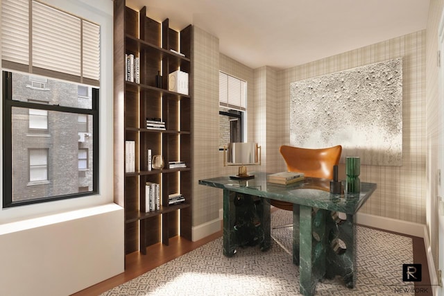 office space with wallpapered walls, baseboards, and wood finished floors