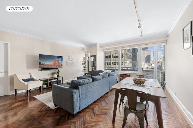 living room with ornamental molding, rail lighting, visible vents, and baseboards