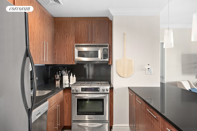 kitchen with tasteful backsplash, decorative light fixtures, crown molding, and stainless steel appliances