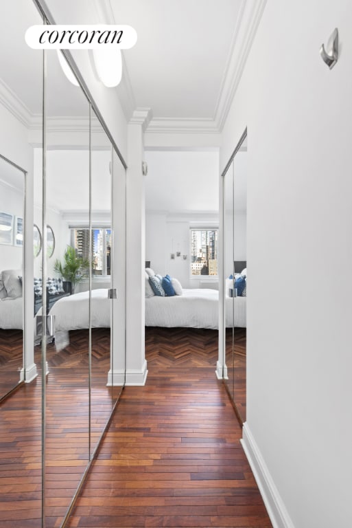 hallway featuring dark hardwood / wood-style flooring and ornamental molding