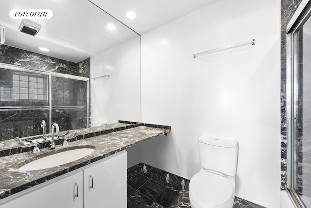 full bathroom with toilet, vanity, and shower / bath combination with glass door