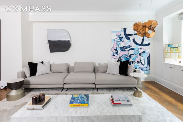 living room featuring crown molding, baseboards, and wood finished floors