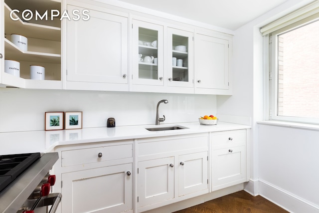 bar with a sink and baseboards