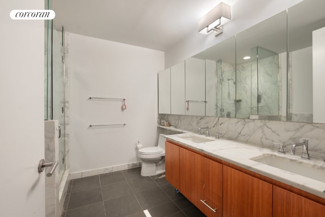 bathroom with backsplash, tile patterned flooring, vanity, walk in shower, and toilet