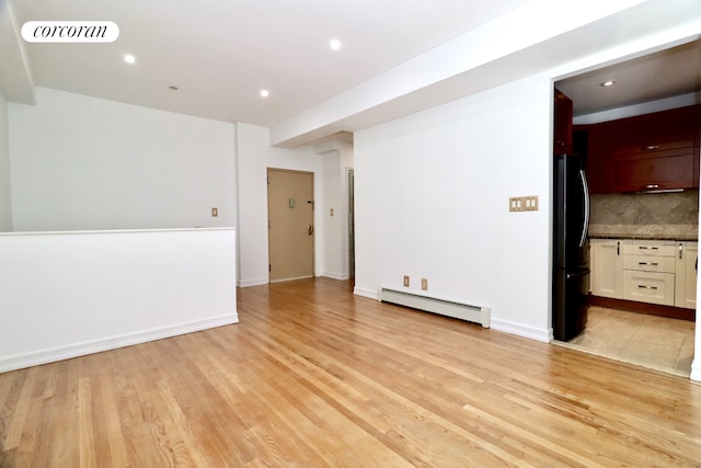 interior space featuring visible vents, recessed lighting, light wood-type flooring, and a baseboard heating unit