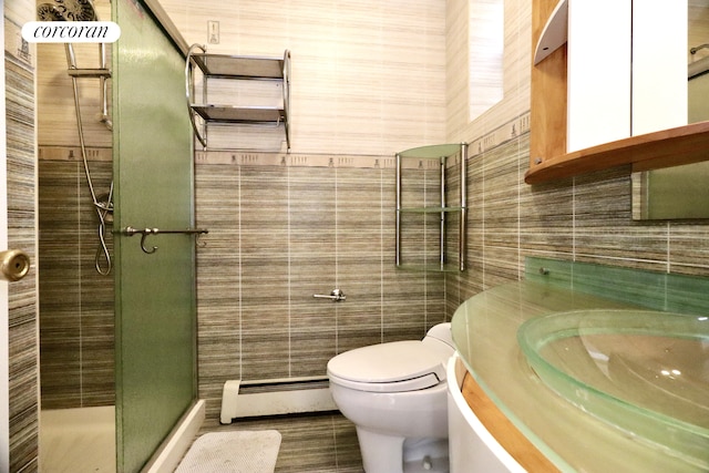 bathroom featuring vanity, a baseboard radiator, a shower stall, tile walls, and toilet