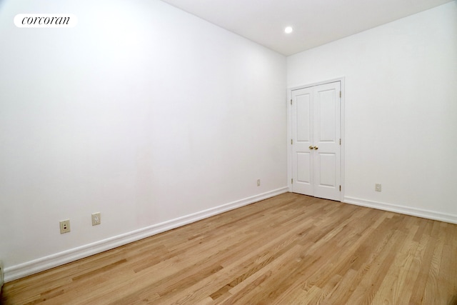 spare room featuring recessed lighting, visible vents, baseboards, and wood finished floors