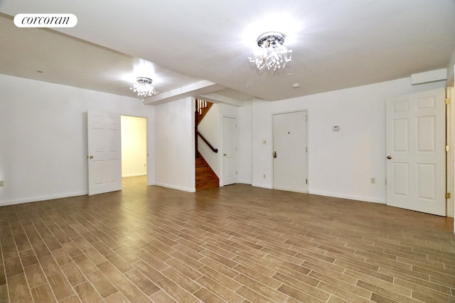 interior space featuring visible vents, baseboards, wood finished floors, and stairs