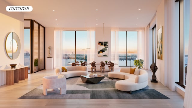 living room featuring a water view, floor to ceiling windows, and light hardwood / wood-style flooring