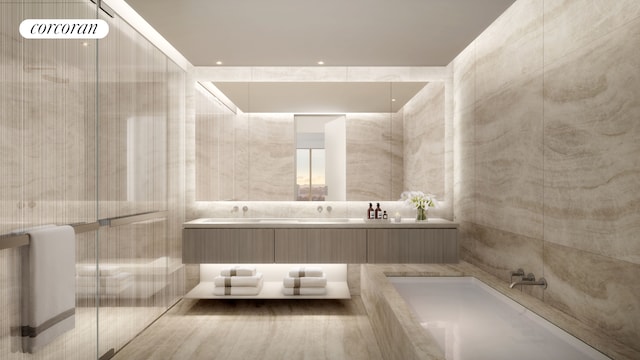 bathroom featuring double vanity, an enclosed shower, a bathtub, and tile walls