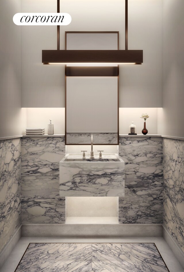 bathroom with plenty of natural light, marble finish floor, visible vents, and a freestanding tub