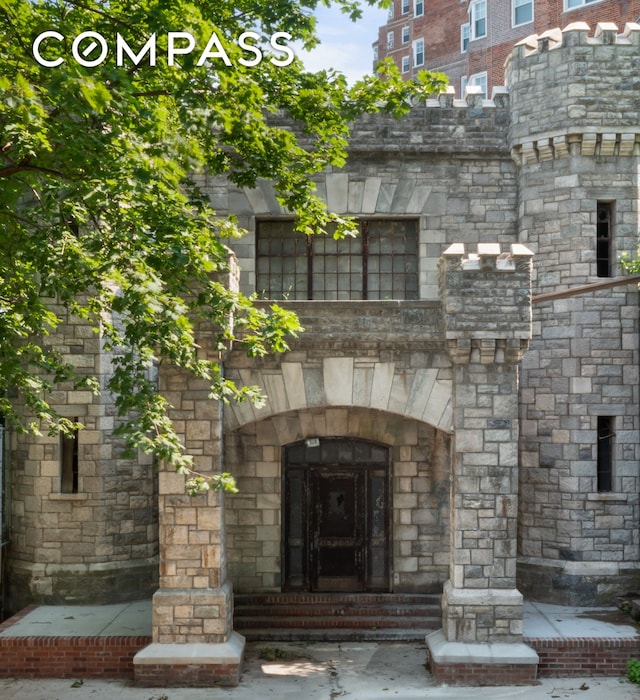 entrance to property featuring stone siding