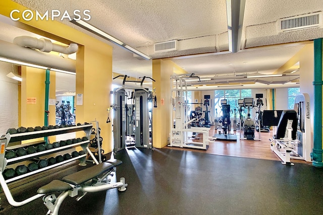 workout area featuring visible vents and a textured ceiling